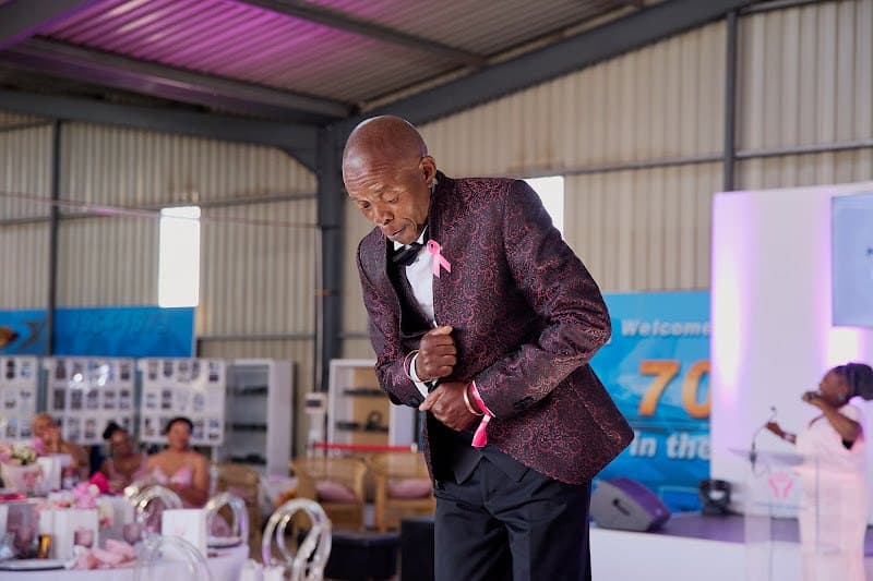 A performer dances on stage as guests watch.