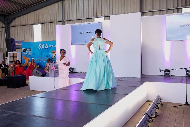 A participant walks the runway in a turquoise gown.
